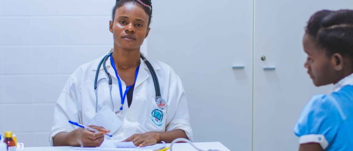 Photo by Francisco Venâncio doctor sitting at the table in front of girl
